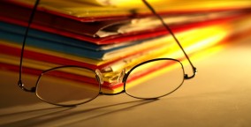 Reading glasses on pile of files