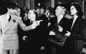 From left, Cary Grant, Frank Jenks, Roscoe Karns, Gene Lockhart, Pat Flaherty, Porter Hall, Alma Kruger & Rosalind Russell in "His Girl Friday"