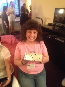 Michele ‘Wojo’ Wojciechowski holds an empty Berger Cookie box in the Hospitality Suite of the 2014 Conference in Washington, D.C.