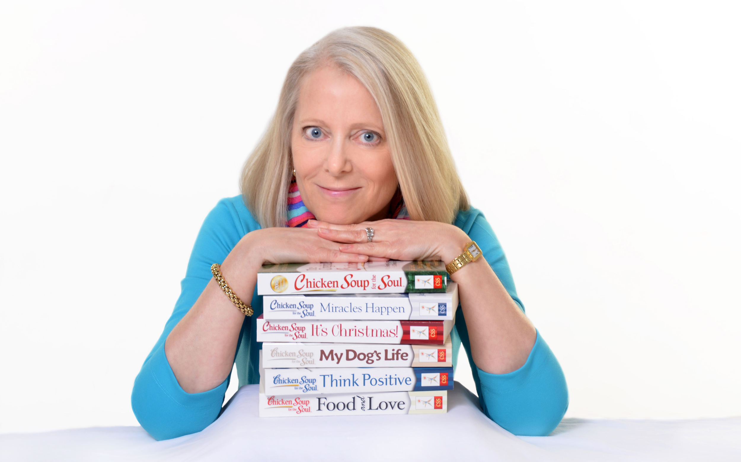 Amy Newmark leaning on stack of Chicken Soup for the Soul Books